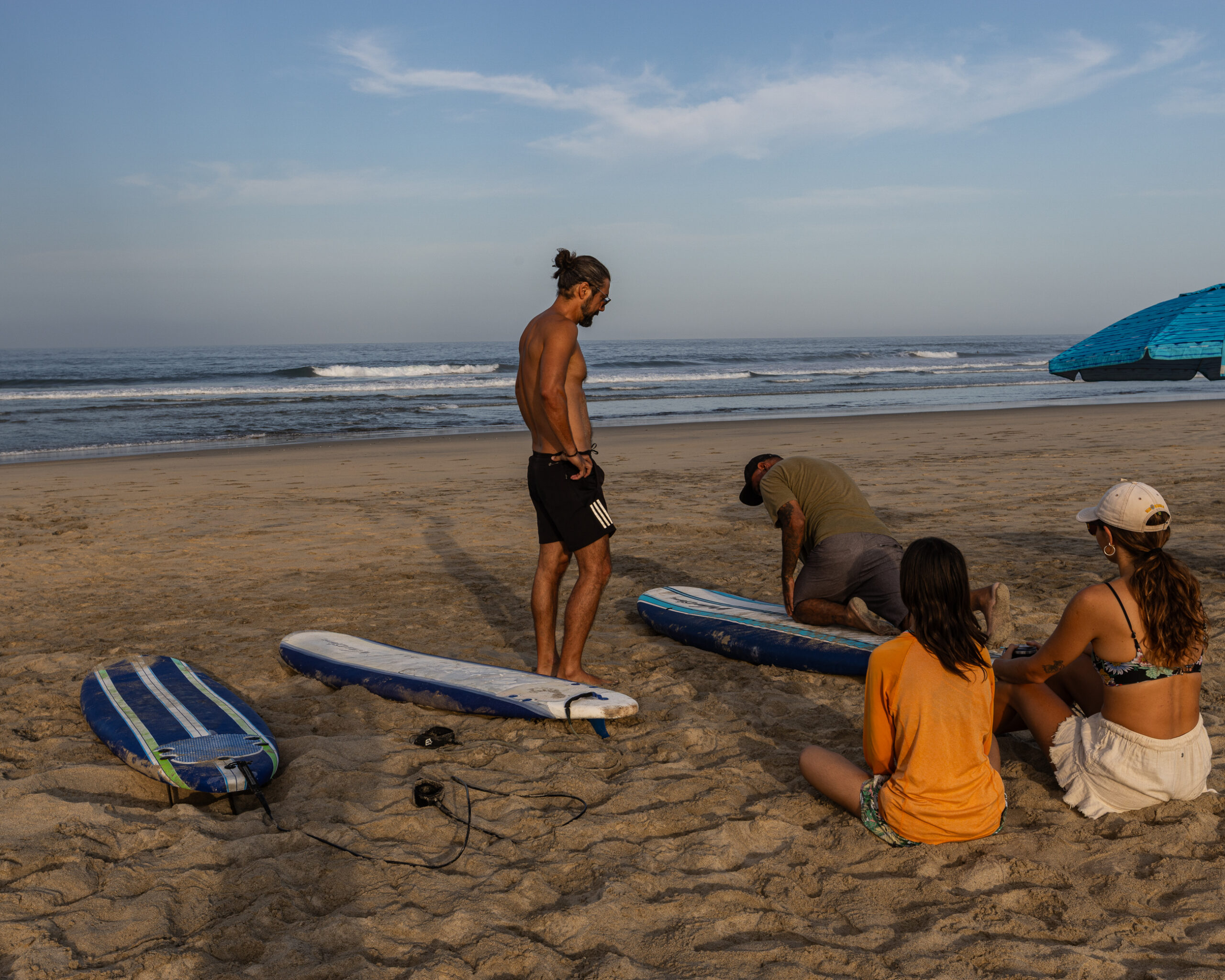 Surf instructor teaching a small group at Cerritos Beach, Baja California Sur